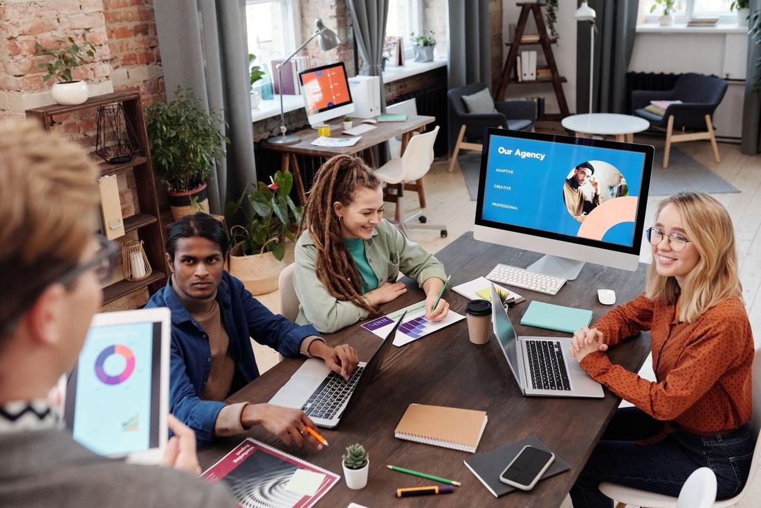 A social media team working with laptops and tablets