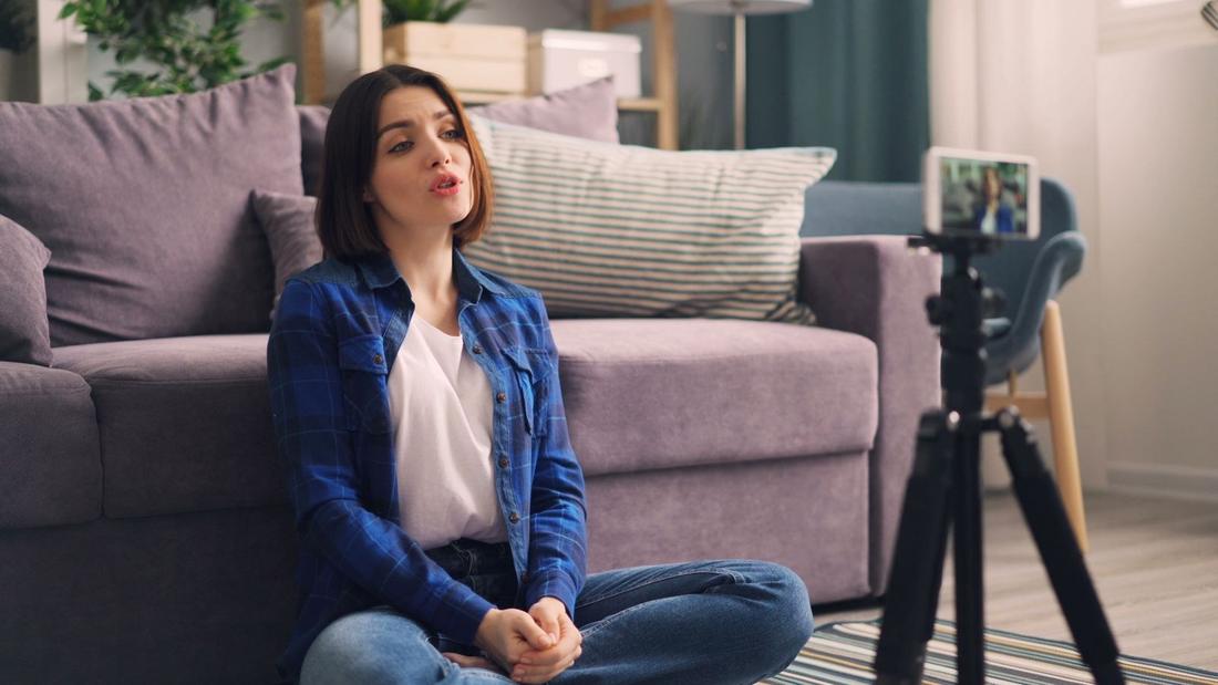 A content creator speaking to a phone on a tripod
