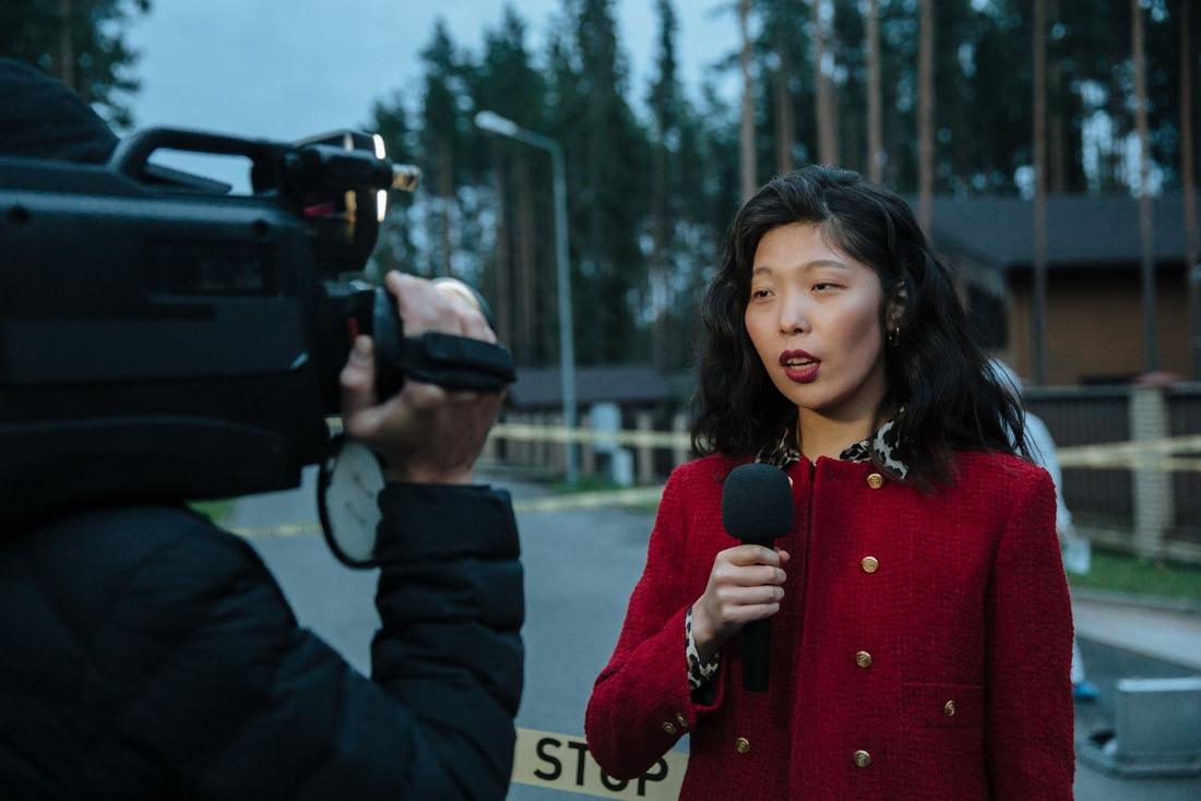 A reporter going live from the field with a camera operator