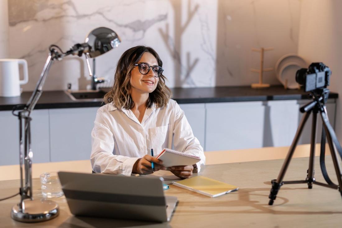 An expert at her desk getting ready to speak to camera